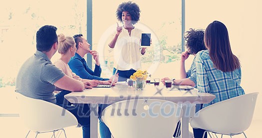 Multiethnic startup business team on meeting in modern bright office interior brainstorming, working on laptop and tablet computer Multiethnic startup business team on meeting in modern bright office interior brainstorming, working on laptop and tablet computer