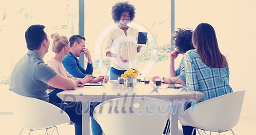 Multiethnic startup business team on meeting in modern bright office interior brainstorming, working on laptop and tablet computer Multiethnic startup business team on meeting in modern bright office interior brainstorming, working on laptop and tablet computer