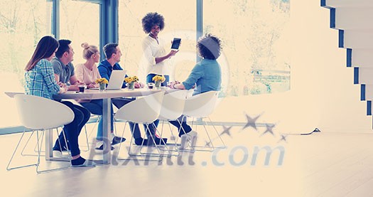 Multiethnic startup business team on meeting in modern bright office interior brainstorming, working on laptop and tablet computer Multiethnic startup business team on meeting in modern bright office interior brainstorming, working on laptop and tablet computer