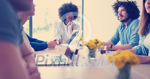 Multiethnic startup business team on meeting in modern bright office interior brainstorming, working on laptop and tablet computer Multiethnic startup business team on meeting in modern bright office interior brainstorming, working on laptop and tablet computer