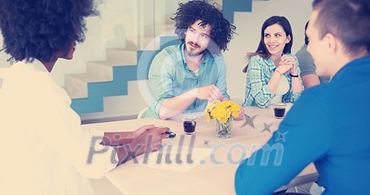 Multiethnic startup business team on meeting in modern bright office interior brainstorming, working on laptop and tablet computer Multiethnic startup business team on meeting in modern bright office interior brainstorming, working on laptop and tablet computer