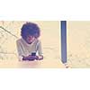 Handsome young african american woman drinking coffee and using a mobile phone at  home