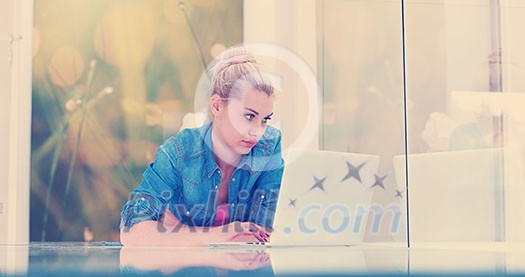 beautiful young women using laptop computer on the floor of her luxury home