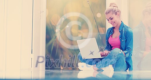 beautiful young women using laptop computer on the floor of her luxury home beautiful young women using laptop computer on the floor of her luxury home