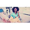 Young african american woman at home relaxing in her luxury lliving room reading a digital tablet PC surf internet and work