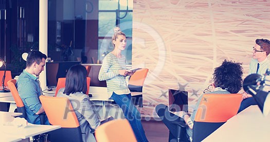 Group of a young business people discussing business plan at modern startup office building Group of a young business people discussing business plan at modern startup office building