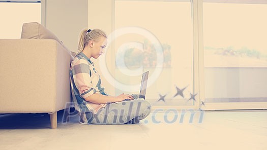 beautiful young women using laptop computer on the floor of her luxury home beautiful young women using laptop computer on the floor of her luxury home