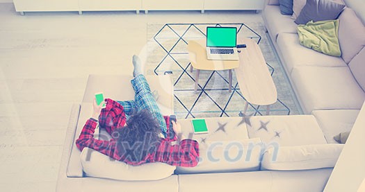 Young couple on the sofa watching television together in their luxury home Young couple on the sofa watching television together in their luxury home