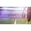 Closeup Portrait of a strong muscular American Football Player on big modern stadium field with lights and flares