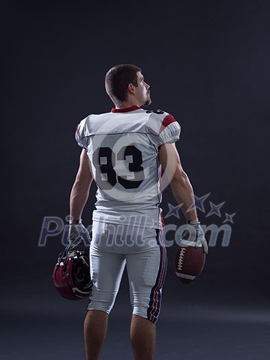 Portrait of a strong muscular American Football Player isolated on gray Portrait of a strong muscular American Football Player isolated on gray