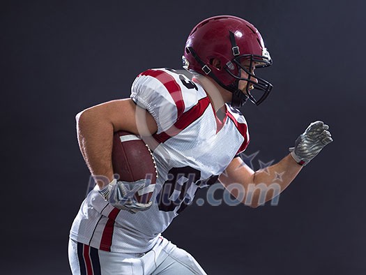 American football Player running with the ball isolated on a gray background American football Player running with the ball isolated on a gray background