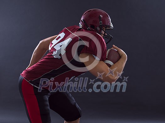 American football Player running with the ball isolated on a gray background American football Player running with the ball isolated on a gray background