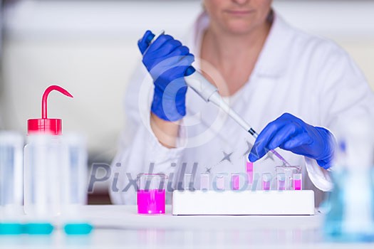 Hands of a female researcher carrying out research in a chemistry lab (color toned image; shallow DOF) Hands of a female researcher carrying out research in a chemistry lab (color toned image; shallow DOF)
