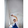 Senior painter man at work with a paint bucket, wall painting concept