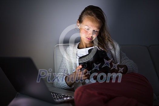 Very tired young woman, burning the midnigh oil - working late at night on her laptop computer, at home, sitting on sofa, rubbing her tired eyes, trying to stay focused Very tired young woman, burning the midnigh oil - working late at night on her laptop computer, at home, sitting on sofa, rubbing her tired eyes, trying to stay focused
