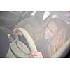 Pretty young woman driving her new car