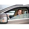 Pretty young woman driving her new car (shallow DOF; color toned image)
