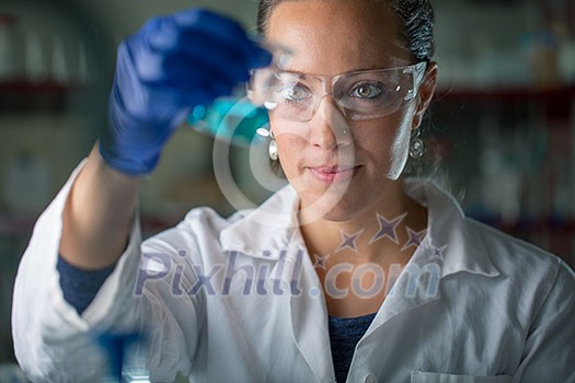 Female researcher carrying out scientific research in a lab (shallow DOF; color toned image) Female researcher carrying out scientific research in a lab (shallow DOF; color toned image)