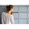 Pretty, young woman checking her mailbox for new letters