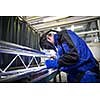 Industrial workers welding metal with many sharp sparks, Welder working a welding metal with protective mask and sparks