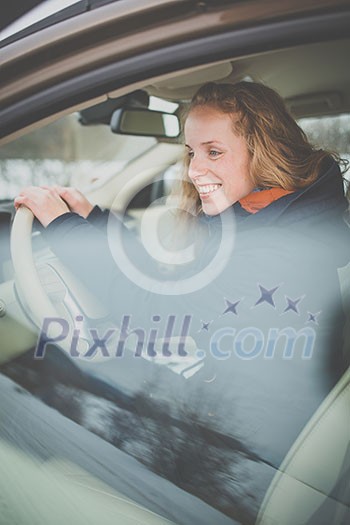 Pretty young woman driving her new car Pretty young woman driving her new car