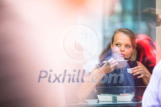 Pretty, young woman eating sushi in a restaurant, having her lunch break, enjoying the food, pausing for a while from her busy corporate/office life (color toned image) Pretty, young woman eating sushi in a restaurant, having her lunch break, enjoying the food, pausing for a while from her busy corporate/office life (color toned image)