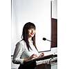 Pretty, young business woman giving a presentation in a conference/meeting setting (shallow DOF; color toned image)