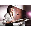 Pretty, young business woman giving a presentation in a conference/meeting setting (shallow DOF; color toned image)