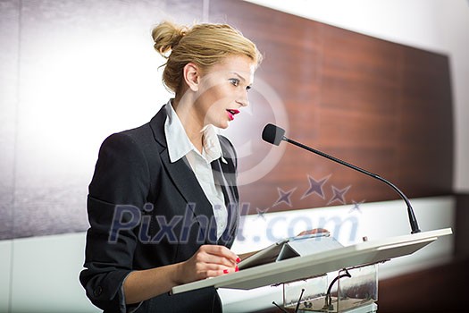 Pretty, young business woman giving a presentation in a conference/meeting setting (shallow DOF; color toned image) Pretty, young business woman giving a presentation in a conference/meeting setting (shallow DOF; color toned image)