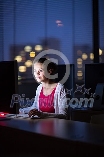 Pretty, young female college student using a desktop computer/pc in a college library (shallow DOF; color toned image) Pretty, young female college student using a desktop computer/pc in a college library (shallow DOF; color toned image)