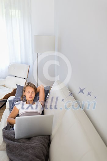 Gorgeous young woman using her tablet computer while working from home Gorgeous young woman using her tablet computer while working from home