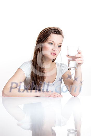 Closeup portrait of a young attractive woman drinking water from glass. Closeup portrait of a young attractive woman drinking water from glass.