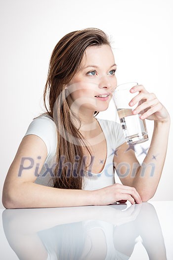 Closeup portrait of a young attractive woman drinking water from glass. Closeup portrait of a young attractive woman drinking water from glass.