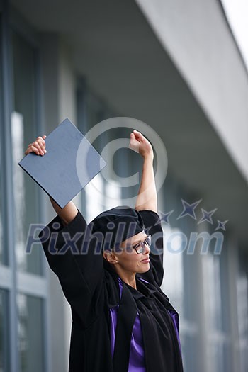 Pretty, young woman celebrating joyfully her graduation - cheking her diploma, happy/impressed with the title she received (color toned image; shallow DOF) Pretty, young woman celebrating joyfully her graduation - cheking her diploma, happy/impressed with the title she received (color toned image; shallow DOF)