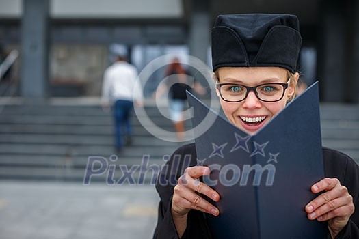 Pretty, young woman celebrating joyfully her graduation - cheking her diploma, happy/impressed with the title she received (color toned image; shallow DOF) Pretty, young woman celebrating joyfully her graduation - cheking her diploma, happy/impressed with the title she received (color toned image; shallow DOF)