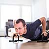 Handsome young man doing push-up at home, getting stronger each day using only his body weight