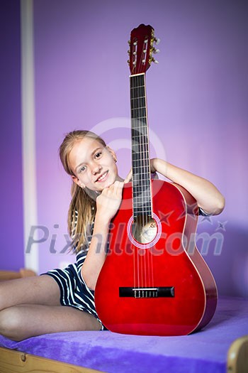 Teenage girl with her guitar in her lovely room Teenage girl with her guitar in her lovely room