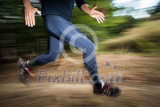 Young man running outdoors in a forest, going fast (motion blurred image) Young man running outdoors in a forest, going fast (motion blurred image)