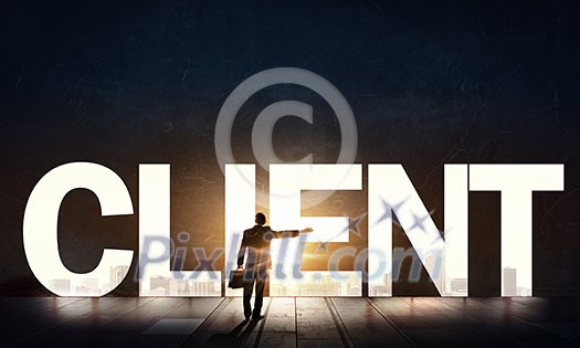 Back view of businessman standing in light of word client Back view of businessman standing in light of word client