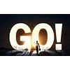 Back view of businessman standing in light of GO word