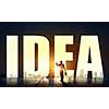 Back view of businessman standing in light of word idea