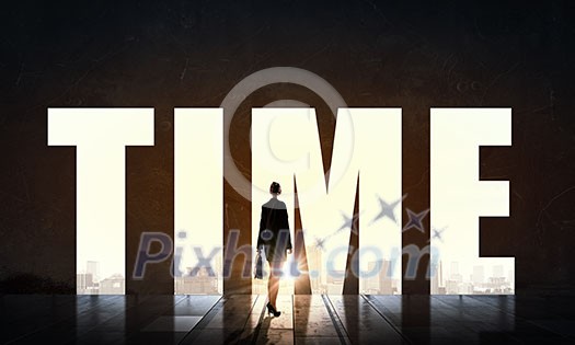 Back view of businesswoman standing in light of word time Back view of businesswoman standing in light of word time