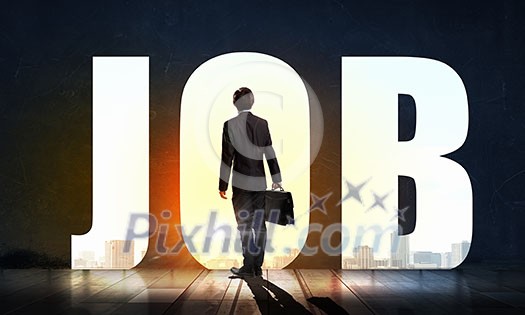 Back view of businessman standing in light of word job Back view of businessman standing in light of word job