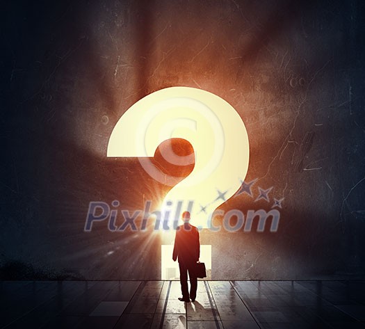 Back view of businessman standing in light of big question mark Back view of businessman standing in light of big question mark