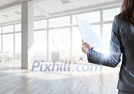 Elegant businesswoman in modern office interior against window panoramic view Elegant businesswoman in modern office interior against window panoramic view