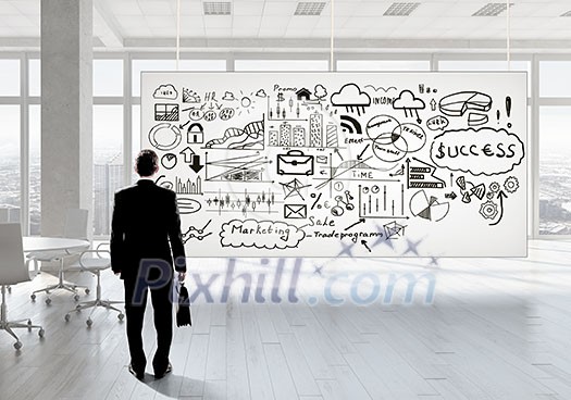 Back view of elegant businessman against banner with business strategy plan Back view of elegant businessman against banner with business strategy plan