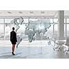 Elegant businesswoman in modern office interior against window panoramic view