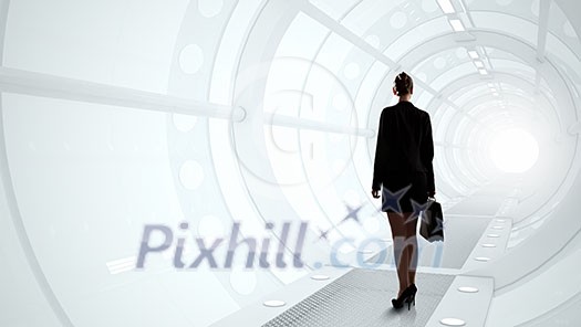 Businesswoman standing in virtual designed tunnel room Businesswoman standing in virtual designed tunnel room