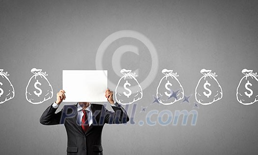 Unrecognizable businessman holding paper covering his face presenting money concept Unrecognizable businessman holding paper covering his face presenting money concept