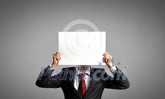 Businessman hiding his face behind paper list Businessman hiding his face behind paper list